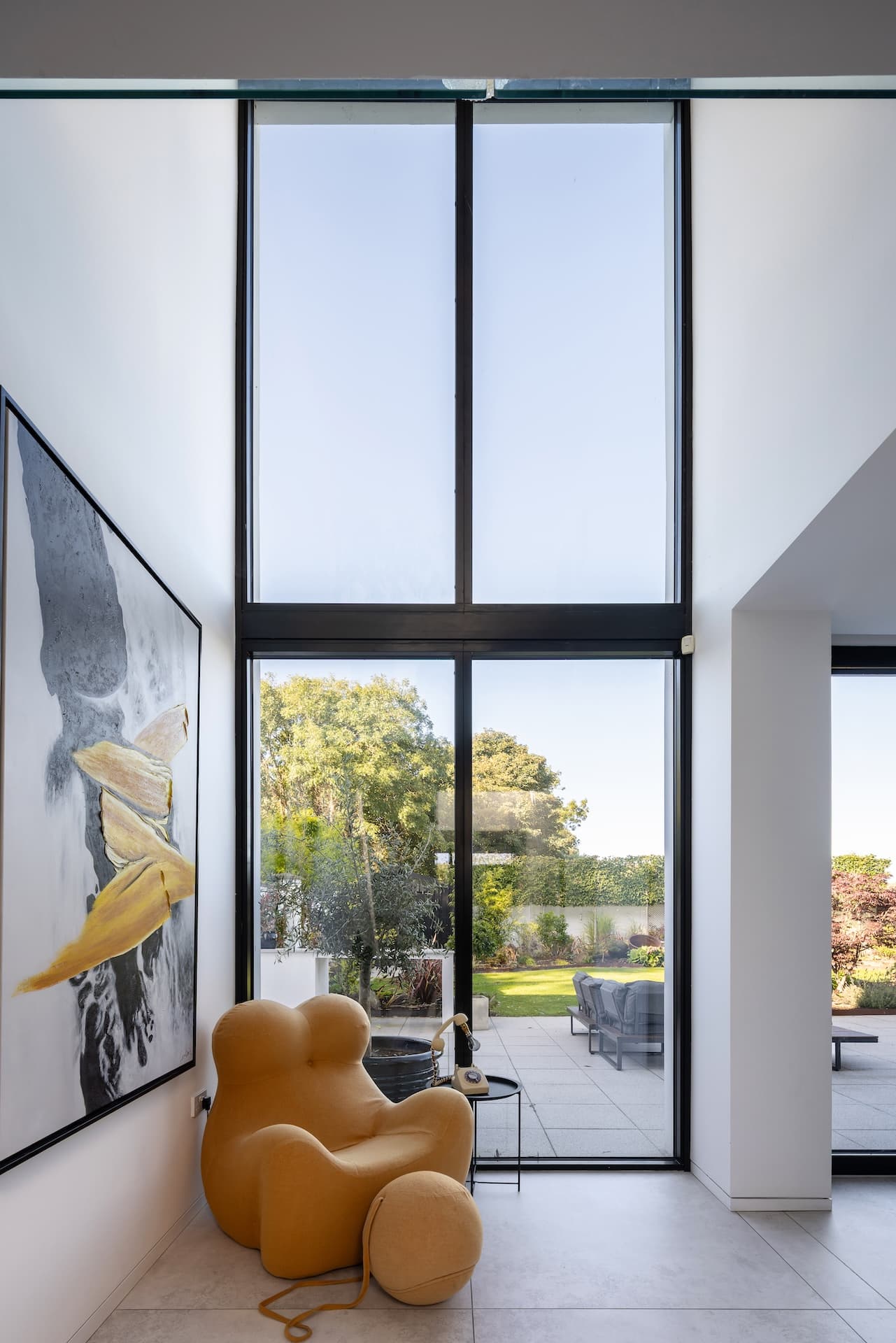 Interior of new build house in Ireland with double height glazed wall to garden
